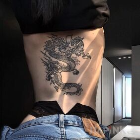 Tattoo Dragon on the back motif: black and gray style: graphic / illustrative