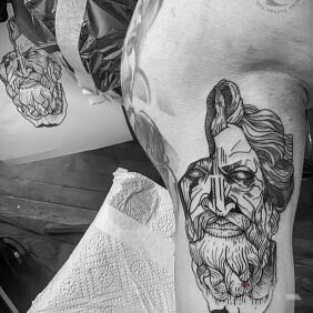 Tattoo Zeus on the upper arm motif: black and gray style: graphic / illustrative