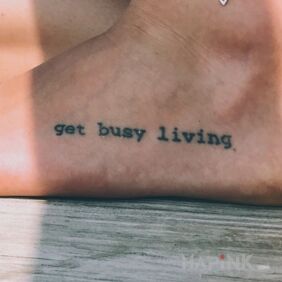 Tattoo Get busy living on the foot motif: lettering style: calligraphy