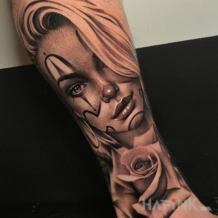 Tattoo Dziewczyna klauna in flowers motif and realistic style on the forearm