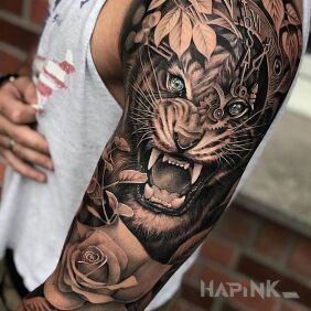 Tattoo Tiger's cloak on the upper arm motif: flowers style: realistic