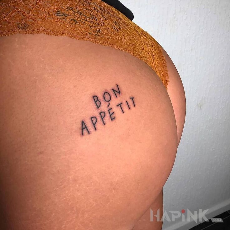 Tattoo Smacznego in lettering motif on the buttocks