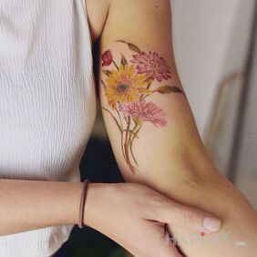 Tattoo Colorful flowers on the upper arm motif: flowers style: realistic