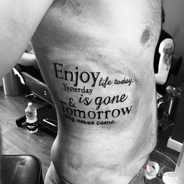 Tattoo Ciesz się dzisiejszym życiem! in lettering motif and calligraphy style on the ribs