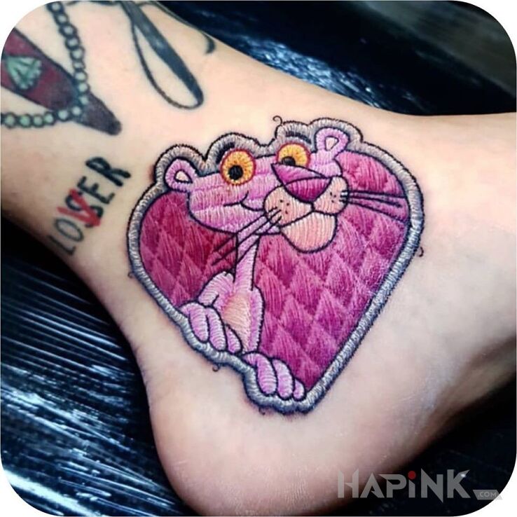 Tattoo Naszywka :) in characters motif and realistic style on the foot