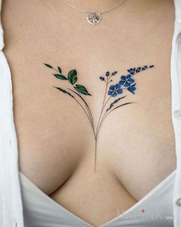 Tattoo Niezapominajka in flowers motif and realistic style on the breast