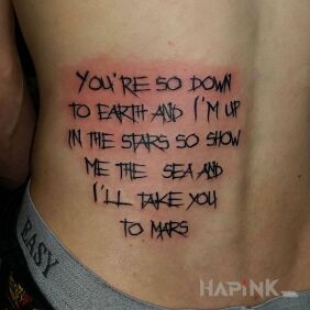 Tattoo Journey to mars on the back motif: lettering style: calligraphy