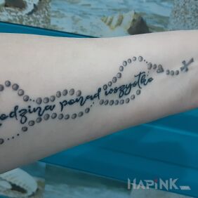 Tattoo Inscription + rosary on the forearm motif: lettering style: calligraphy