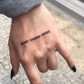 Tattoo Heart on the hand motif: lettering style: calligraphy