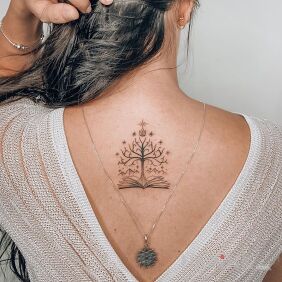 Tattoo Book tree on the back motif: black and gray style: graphic / illustrative