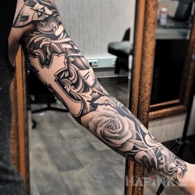 Tattoo Cross with a rose on the upper arm motif: sleeves style: realistic