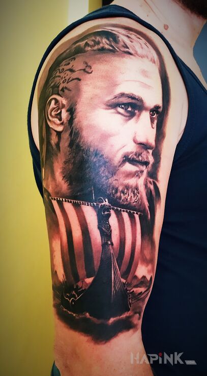 Tattoo Ragnar in faces motif and realistic style on the forearm