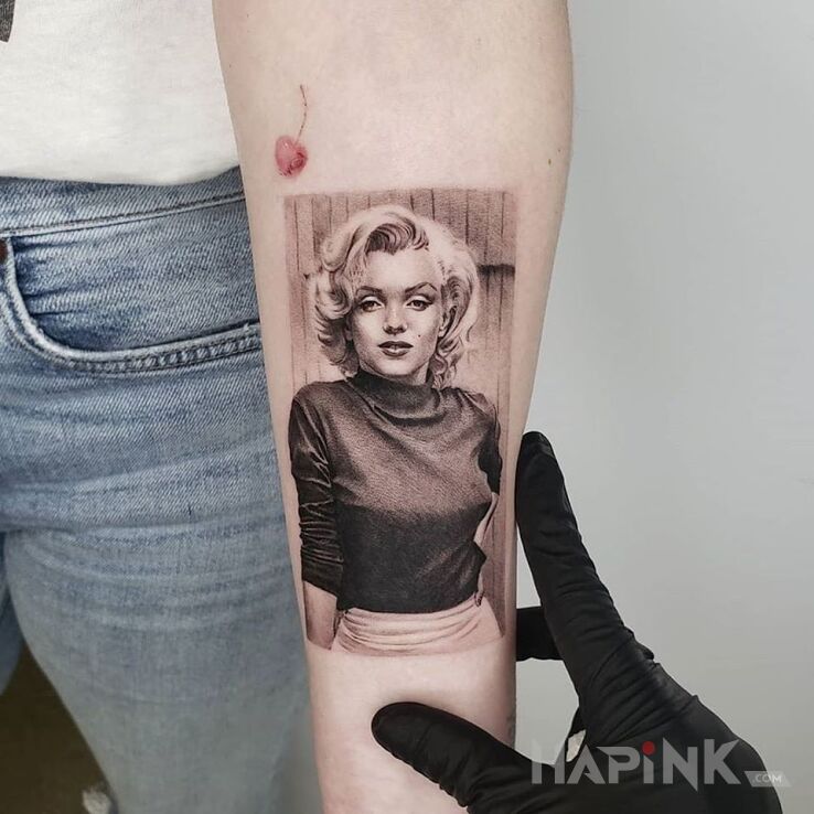 Tattoo Marilyn Monroe in characters motif and realistic style on the forearm