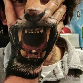 Tattoo Lion's cloak on the hand motif: animals