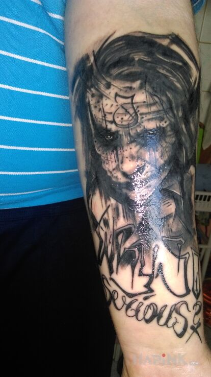 Tattoo Joker in characters motif on the forearm