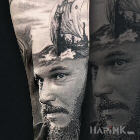 Tattoo Ragnar on the forearm motif: black and gray style: realistic