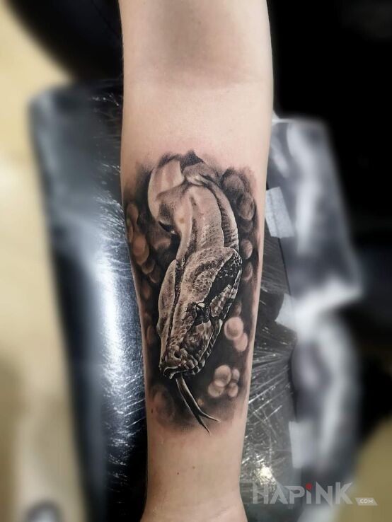 Tattoo Snakemoon in animals motif and realistic style on the forearm