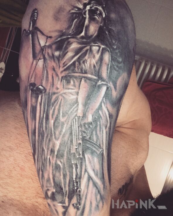 Tattoo Temida z AK47 in black and gray motif and realistic style on the forearm
