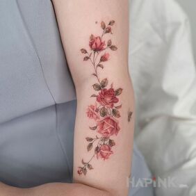 Tattoo Small roses on the upper arm motif: colorful style: realistic