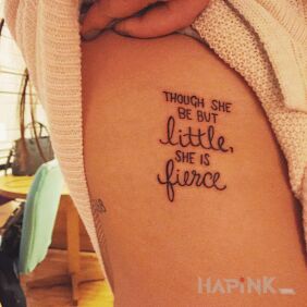 Tattoo Small but fierce on the ribs motif: lettering style: calligraphy