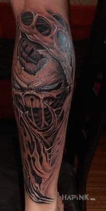 Tattoo Alien in ripped skin motif and graphic / illustrative style on the calf