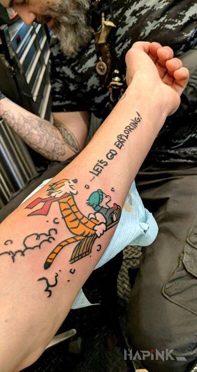 Tattoo Let's go exploring in lettering motif and cartoon / comic book style on the forearm