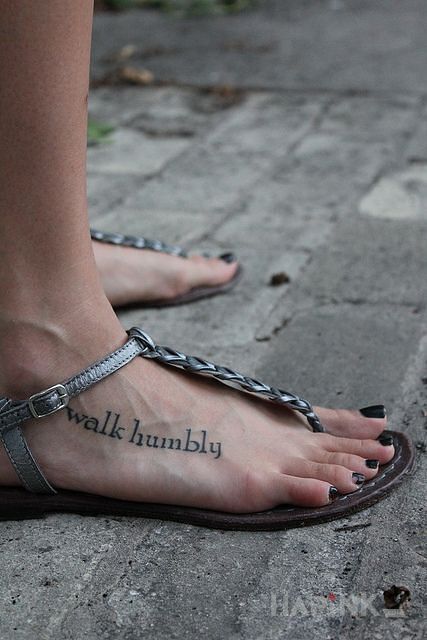 Tattoo Walk humbly in lettering motif and calligraphy style on the foot
