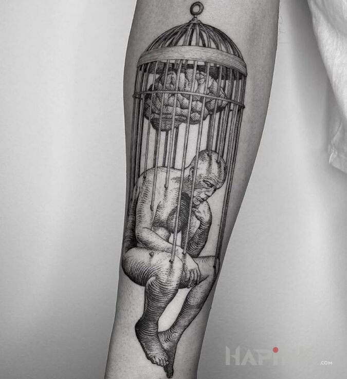 Tattoo W pułapce umysłu in characters motif and engravings / gravure style on the forearm