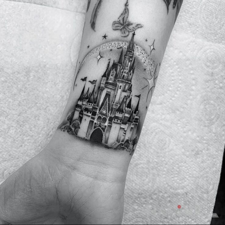 Tattoo Zamek in black and gray motif and realistic style on the wrist