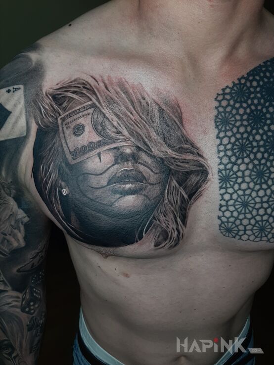 Tattoo Twarz in faces motif and chicano style on the chest