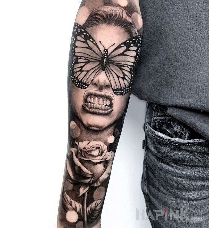 Tattoo Motyl na oczach in flowers motif and realistic style on the forearm