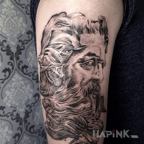 Tattoo And now zeusik on the upper arm motif: faces style: graphic / illustrative