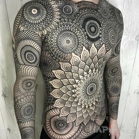 Tattoo Mandala madness on the upper arm motif: black and gray style: geometric
