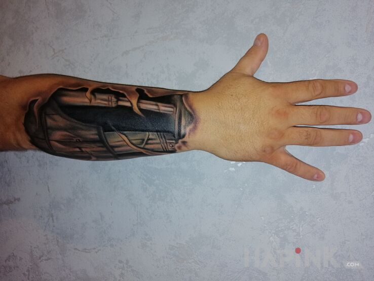Tattoo Robót 2 in ripped skin motif and biomechanics style on the forearm