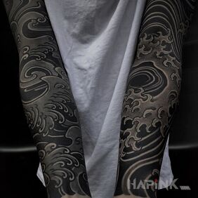 Tattoo Winds and waves on the forearm motif: black and gray style: blackwork / blackout