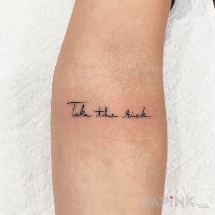 Tattoo Zaryzykuj in lettering motif on the forearm