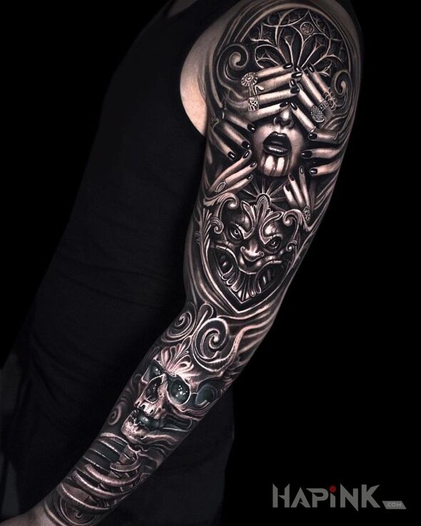 Tattoo Twarz skryta za palcami in skulls motif on the upper arm