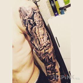 Tattoo Poseidon on the upper arm motif: black and gray style: graphic / illustrative