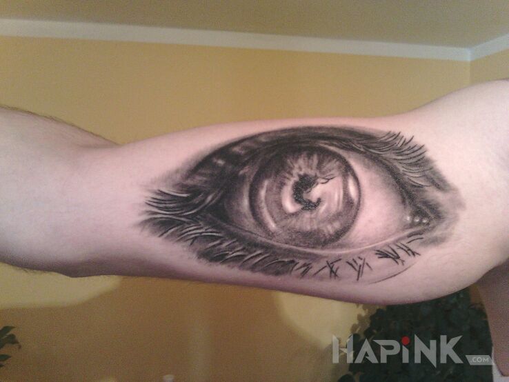 Tattoo Oko in realistic style on the upper arm