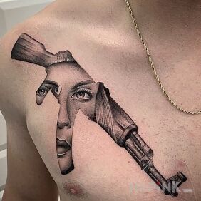 Tattoo A face in a rifle on the chest motif: objects style: graphic / illustrative