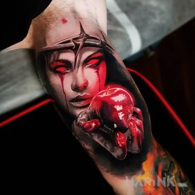 Tattoo Bloody apple on the upper arm motif: colorful style: realistic