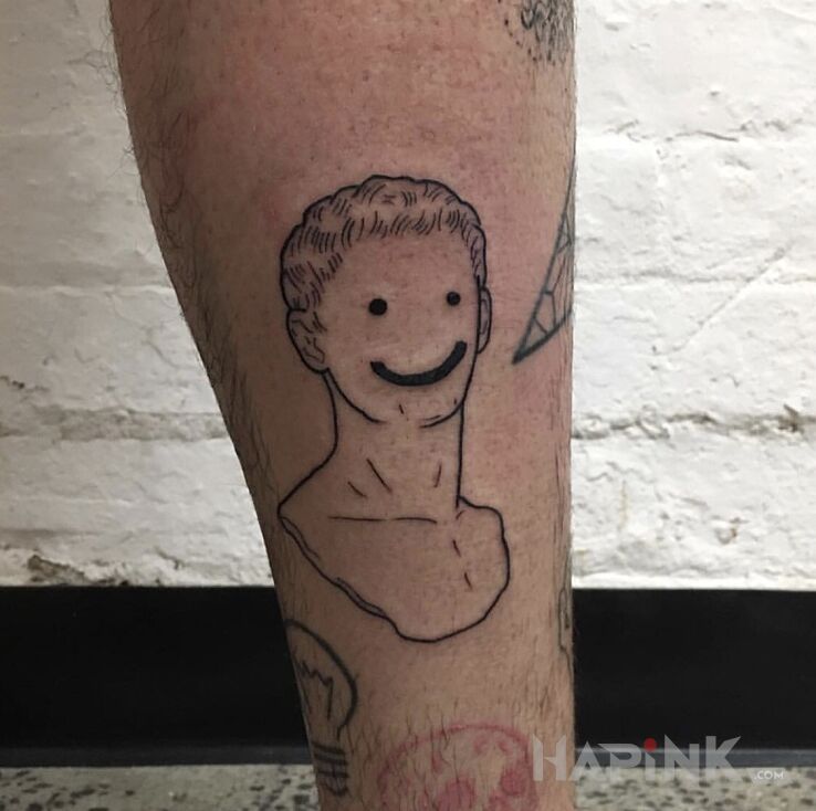 Tattoo Uśmiech :) in faces motif and contour / linework style on the leg