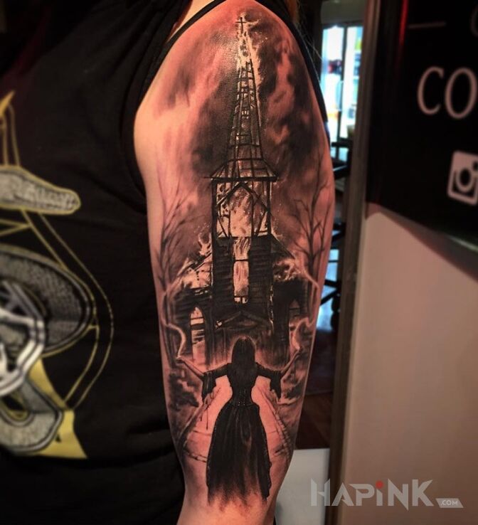 Tattoo Płonący kościół in characters motif on the upper arm