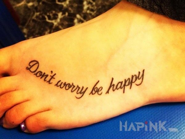Tattoo Unikalny przekaz in lettering motif on the foot