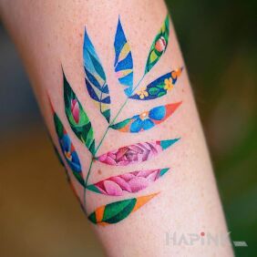 Tattoo A leaf and in it a flower on the forearm motif: colorful style: graphic / illustrative