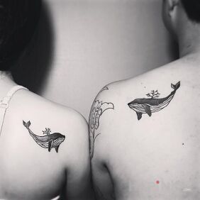Tattoo Whacking on the shoulder blades motif: black and gray style: graphic / illustrative
