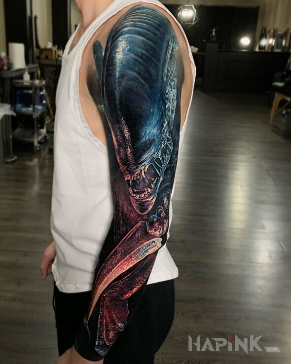 Tattoo Alien obcy in science fiction motif and realistic style on the upper arm