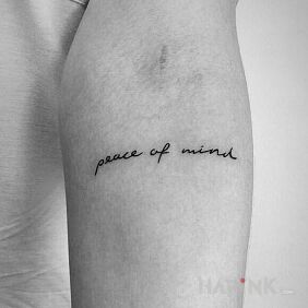 Tattoo Sacred peace on the forearm motif: lettering style: calligraphy