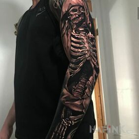 Tattoo Kostucha on the upper arm motif: dark style: realistic
