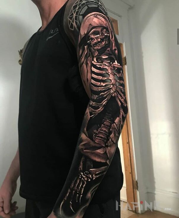 Tattoo Kostucha in skulls motif and realistic style on the forearm
